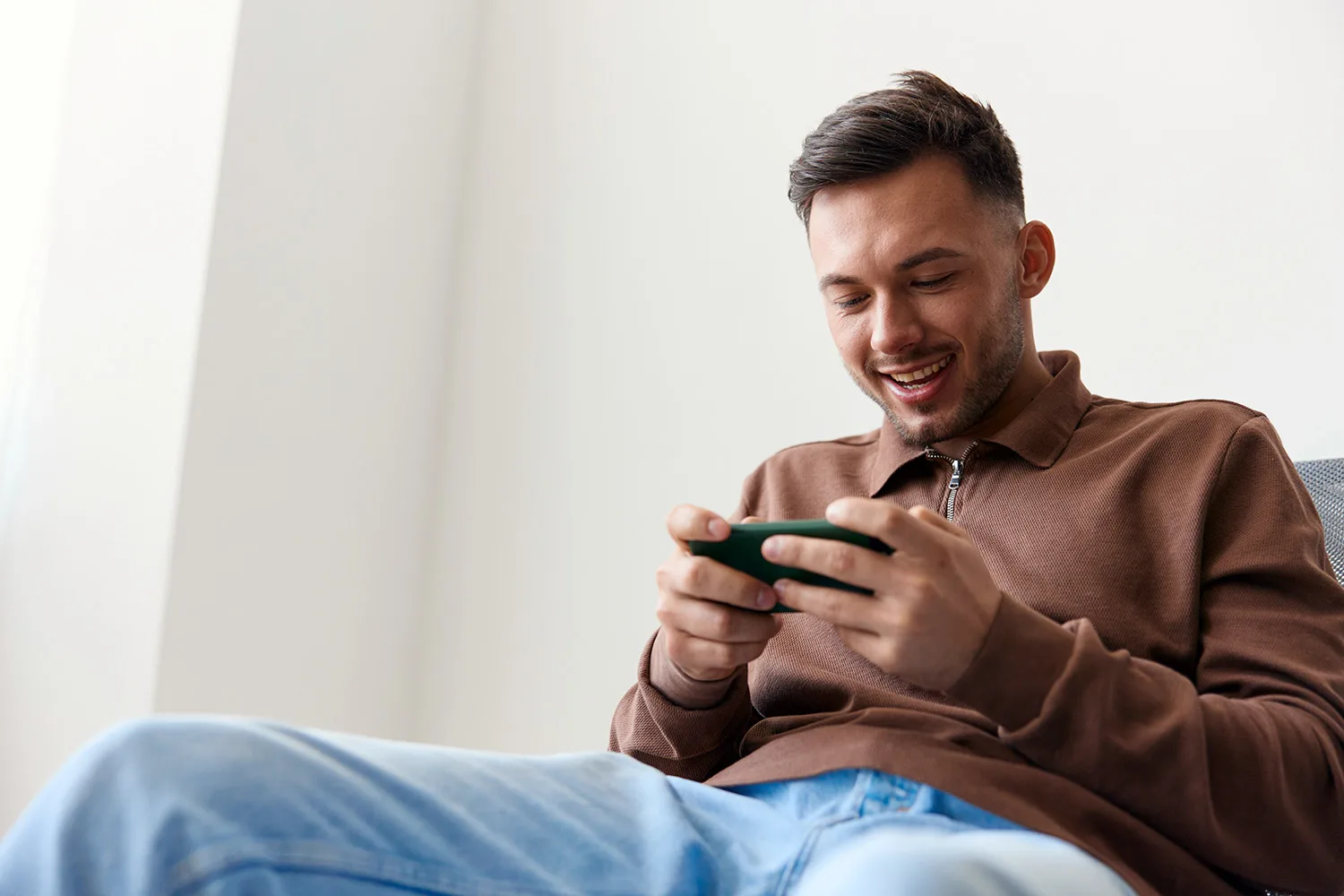 man on mobile playing game
